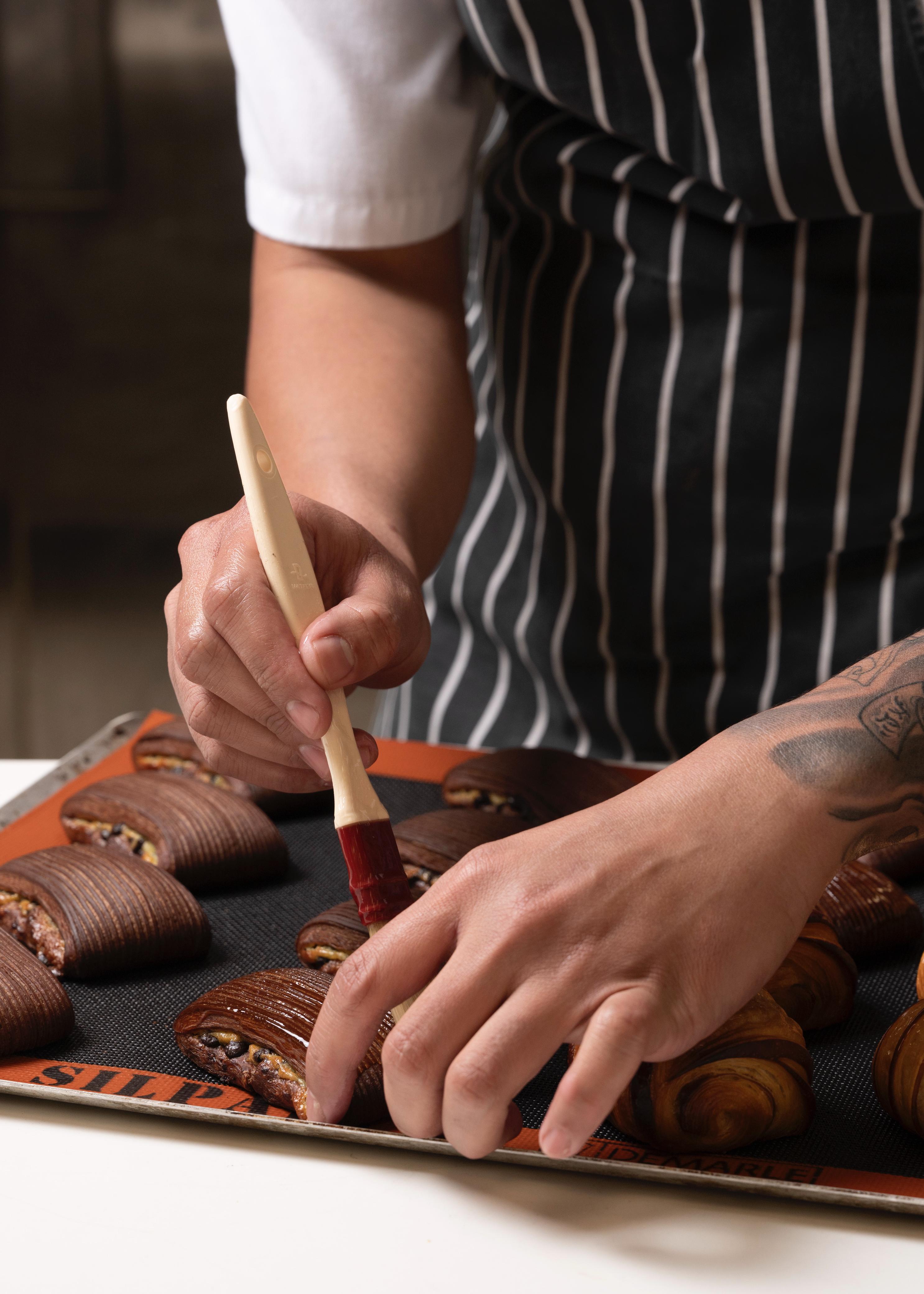 Adi applying finishing touches to pastries